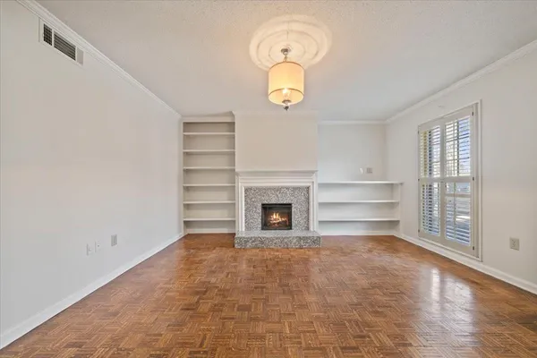 a view of a room with wooden floor and a window