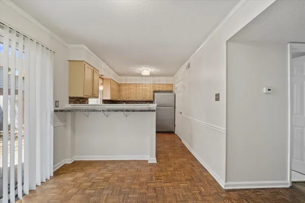 a view of a kitchen with granite countertop cabinets
