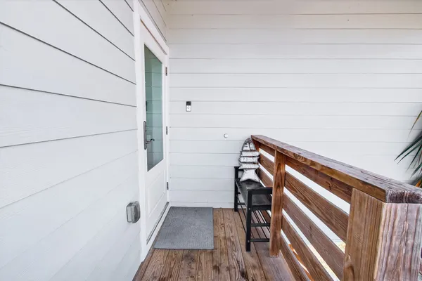 an open kitchen with wooden floor and stainless steel appliances