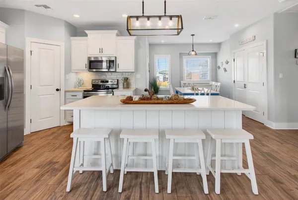 a kitchen with cabinets a sink and appliances