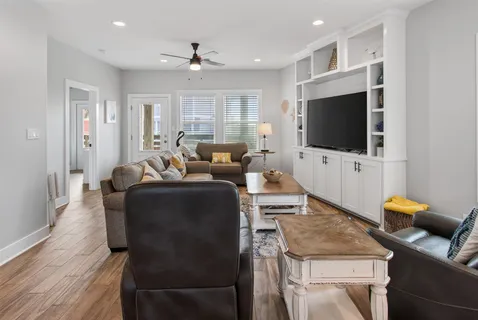a living room with furniture and a large mirror