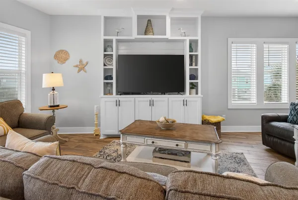 a living room with furniture kitchen view and a table