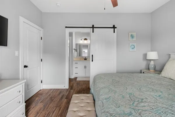 a bathroom with a granite countertop sink toilet a mirror a vanity and shower