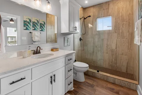 a bathroom with a sink a toilet and mirror