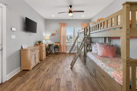 a bedroom with furniture and a wooden floor