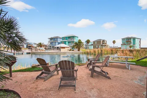 a view of a backyard with furniture and a fire pit