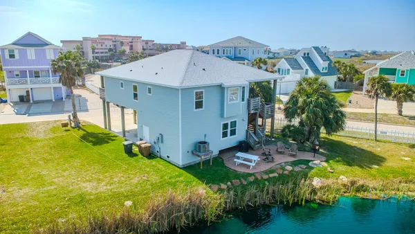 a view of a house with pool and sitting area