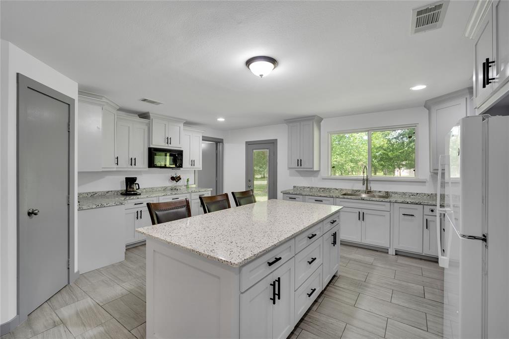 10476 County Road 313 Terrell, TX 75161 - Photo 11 of 40 a kitchen with white cabinets and appliances