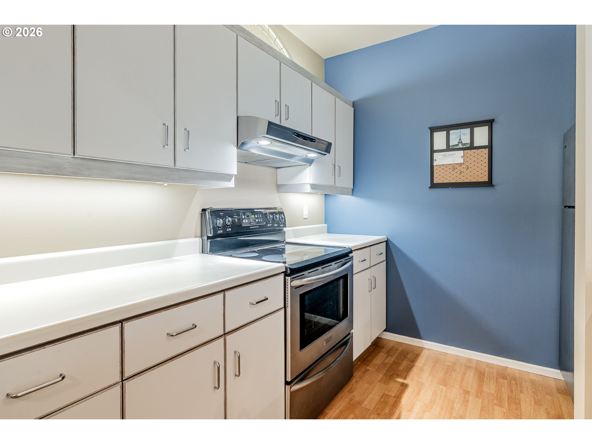 205 South Montgomery Street, Unit 401B Portland, OR 97201 - Photo 11 of 33 a kitchen with granite countertop a sink a stove and cabinets