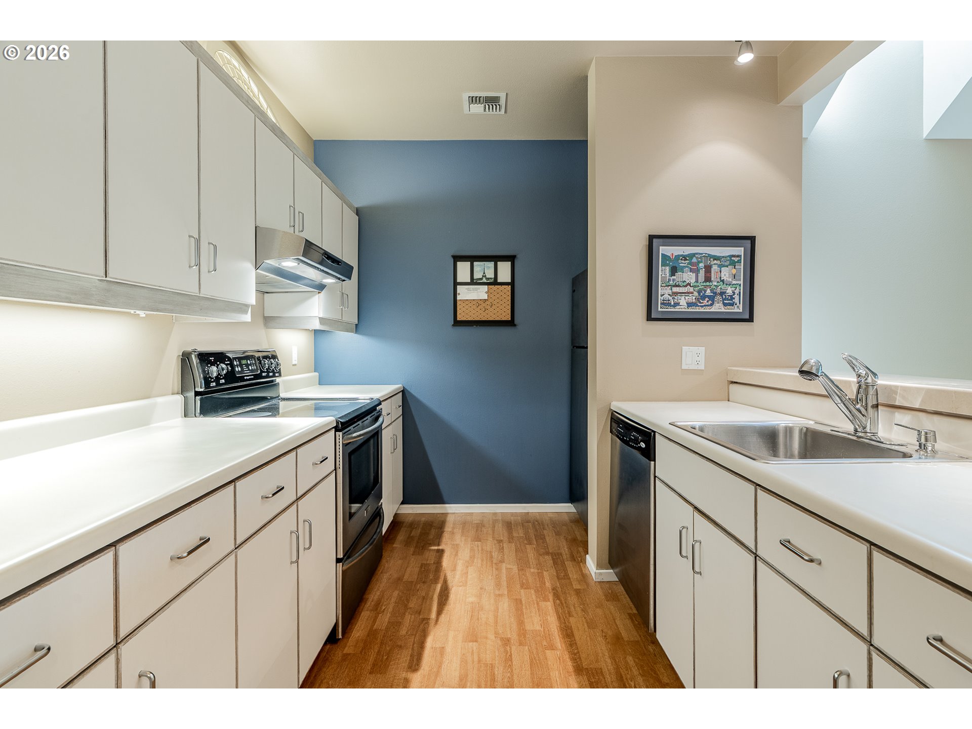 205 South Montgomery Street, Unit 401B Portland, OR 97201 - Photo 10 of 33 a kitchen with granite countertop a sink cabinets and stainless steel appliances