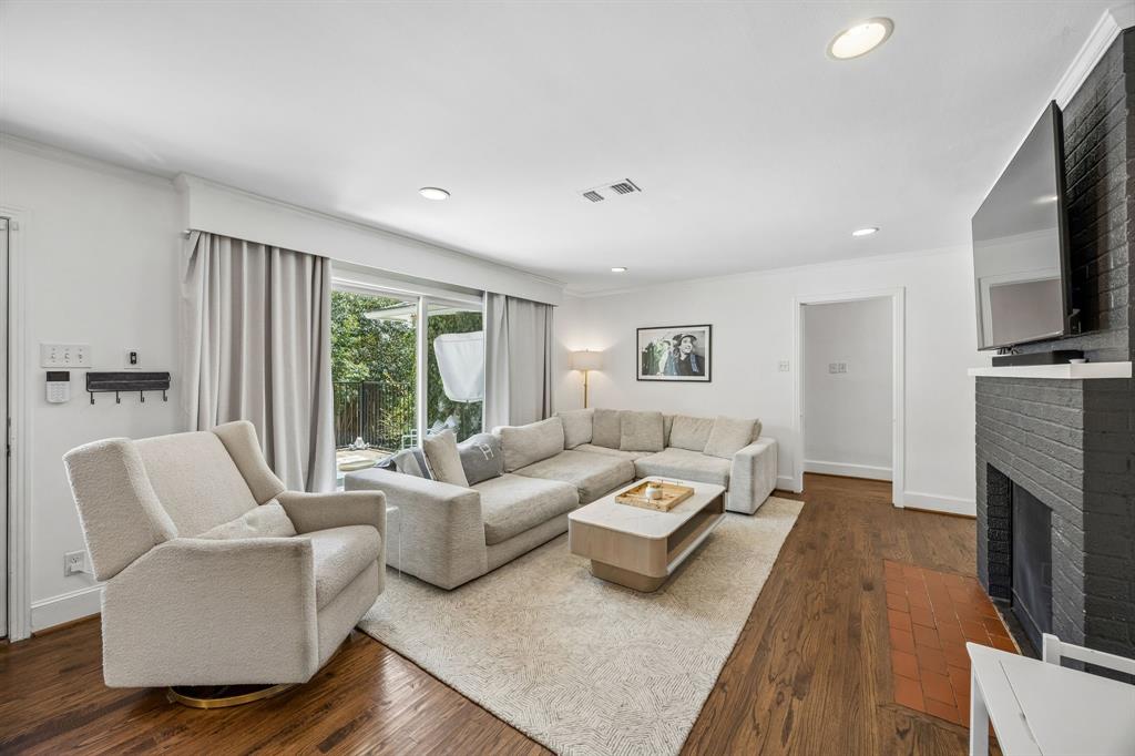 5130 Rexton Lane Dallas, TX 75214 - Photo 11 of 28 a living room with furniture flat screen tv and a fireplace