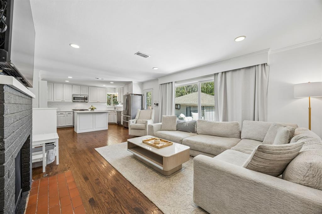 5130 Rexton Lane Dallas, TX 75214 - Photo 12 of 28 a living room with furniture and a fireplace