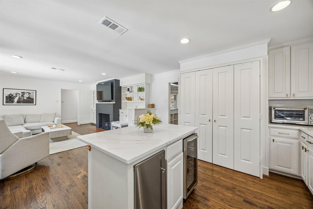 5130 Rexton Lane Dallas, TX 75214 - Photo 13 of 28 a view of kitchen island a sink wooden floor and living room