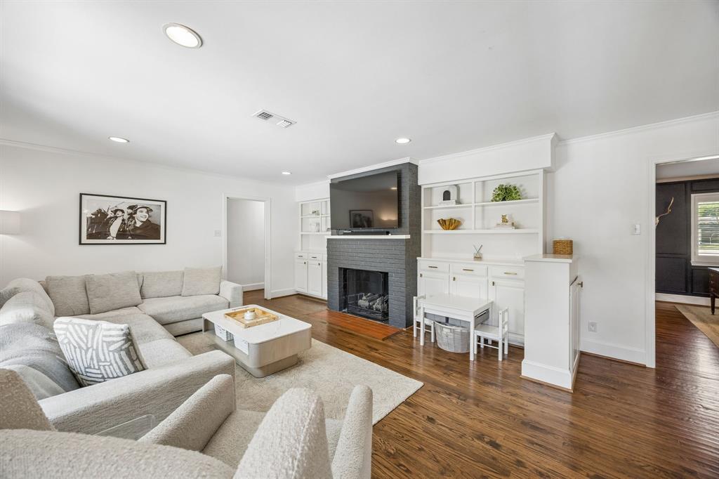 5130 Rexton Lane Dallas, TX 75214 - Photo 9 of 28 a living room with furniture a fireplace and a flat screen tv