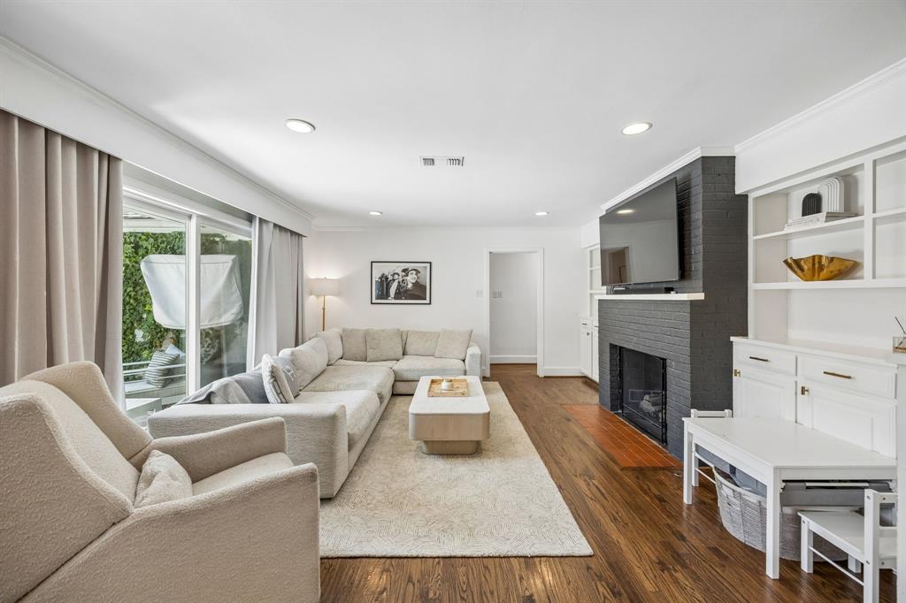 5130 Rexton Lane Dallas, TX 75214 - Photo 10 of 28 a living room with furniture a fireplace and a flat screen tv