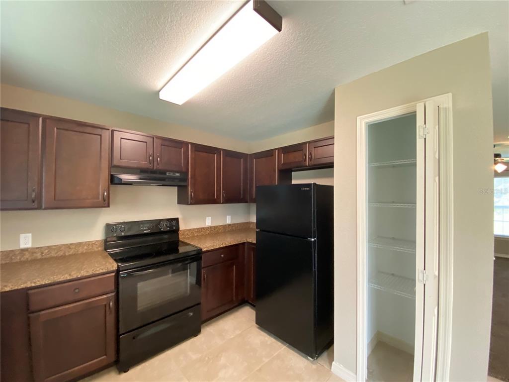 2559 Southwest 159th Lane Ocala, FL 34473 - Photo 11 of 22 a kitchen with a refrigerator and a sink