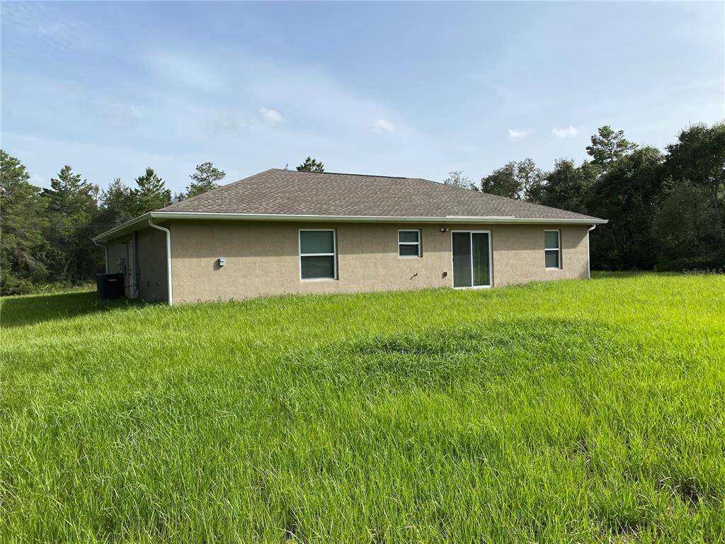 2559 Southwest 159th Lane Ocala, FL 34473 - Photo 21 of 22 a front view of house with yard and green space