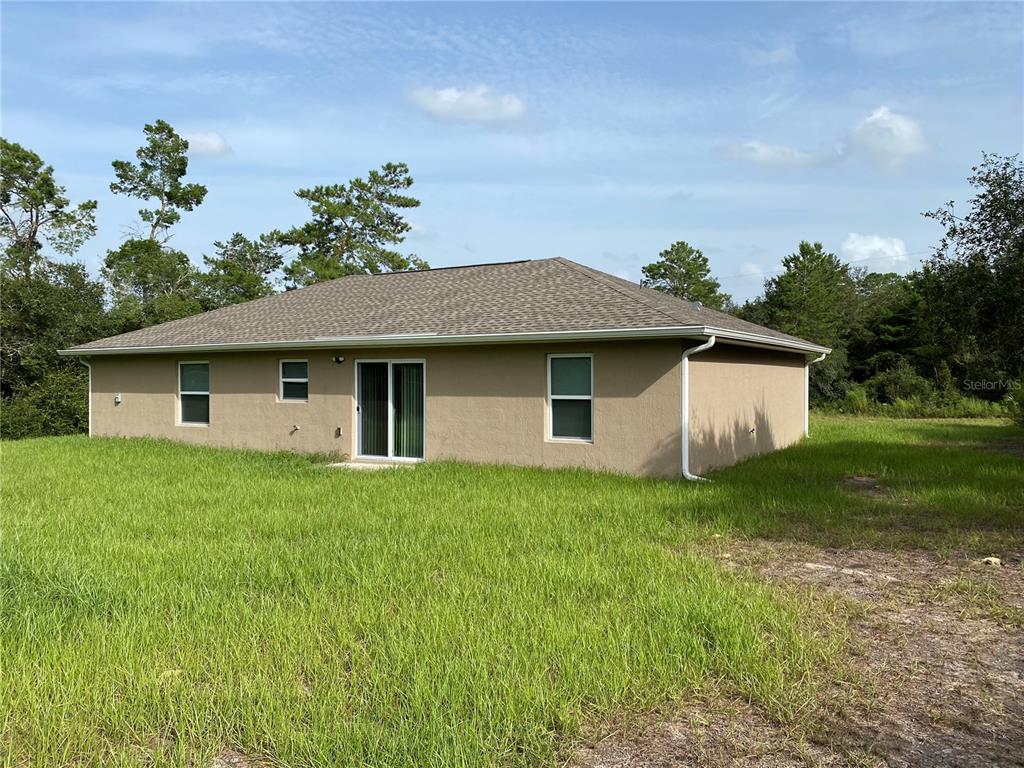 2559 Southwest 159th Lane Ocala, FL 34473 - Photo 22 of 22 a view of a house with a yard