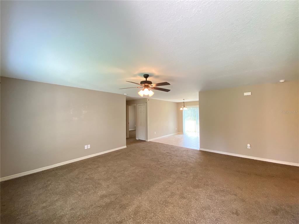 2559 Southwest 159th Lane Ocala, FL 34473 - Photo 4 of 22 a view of a big room with windows and chandelier fan
