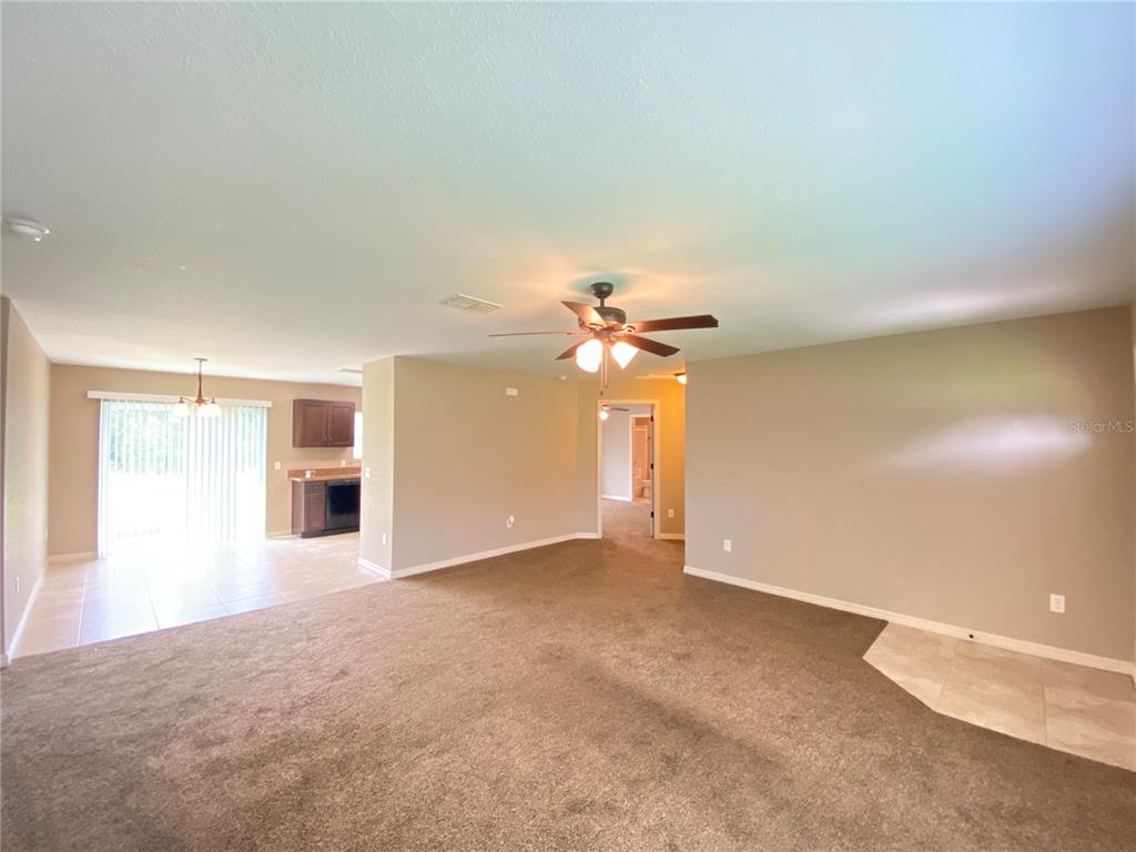 2559 Southwest 159th Lane Ocala, FL 34473 - Photo 5 of 22 a view of a big room with windows and chandelier fan