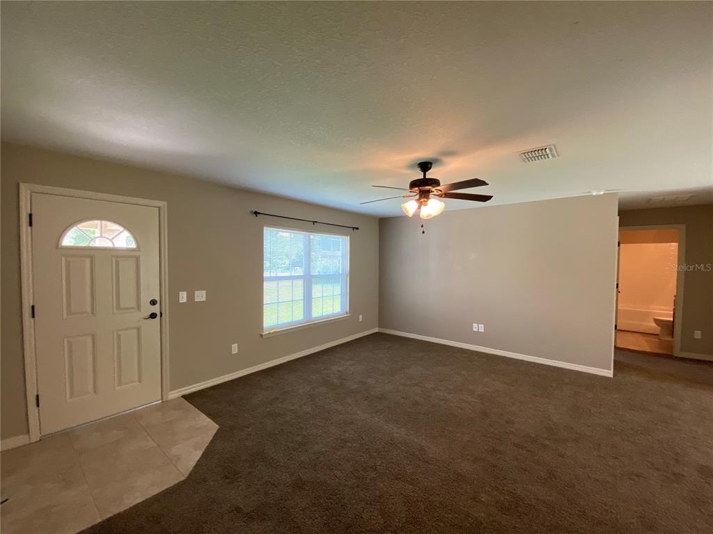 2559 Southwest 159th Lane Ocala, FL 34473 - Photo 7 of 22 an empty room with windows and fan chandelier