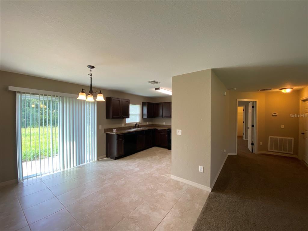 2559 Southwest 159th Lane Ocala, FL 34473 - Photo 8 of 22 a view of a kitchen with a sink and a refrigerator