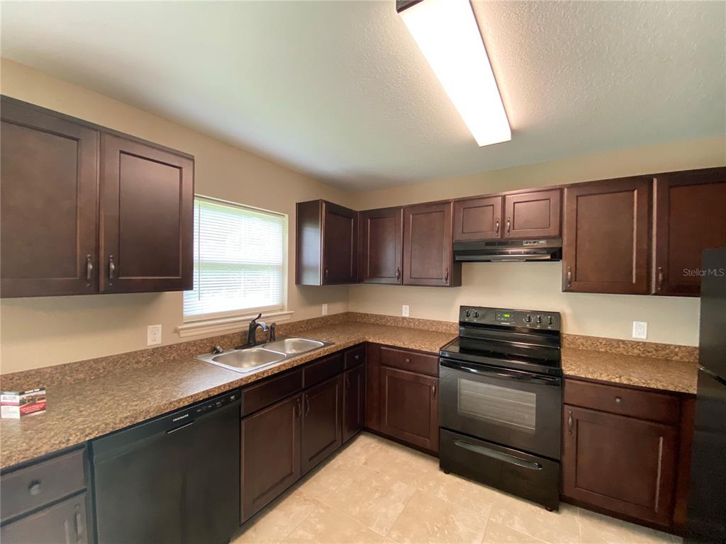 2559 Southwest 159th Lane Ocala, FL 34473 - Photo 10 of 22 a kitchen with kitchen island granite countertop a sink stainless steel appliances and cabinets