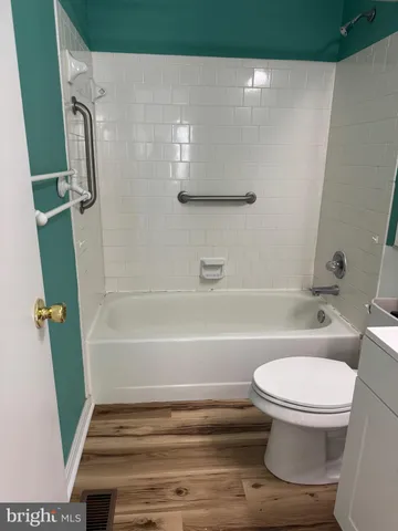 a bathroom with a toilet and a bath tub