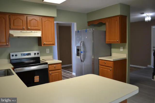 a kitchen with a refrigerator stove and sink