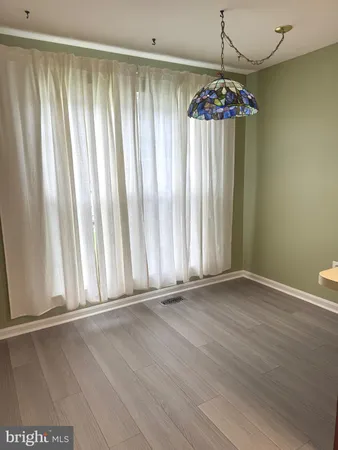 a view of wooden floor and chandelier in a room