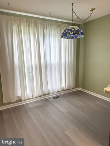 a view of wooden floor and chandelier in a room