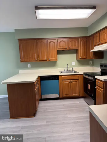 a kitchen with a sink a stove cabinets and a kitchen island
