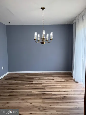 a view of a chandelier fan and wooden floor