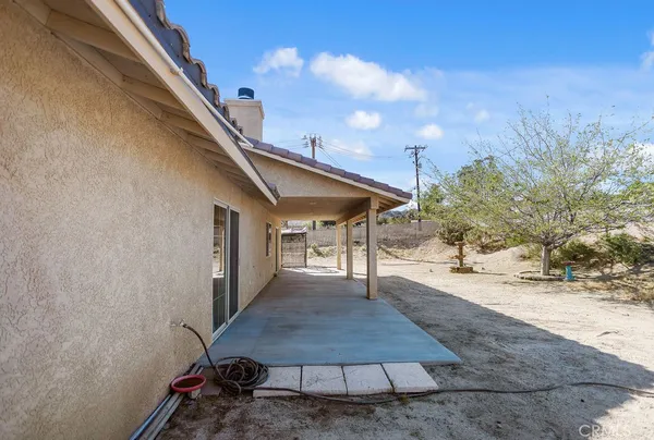 a backyard of a house with table and chairs