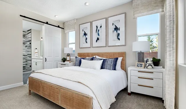 a living room with furniture a large window and a sink