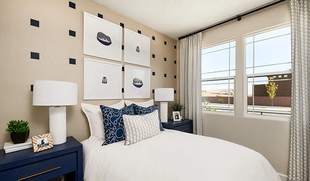 a bedroom with a large bed and a painting on the wall