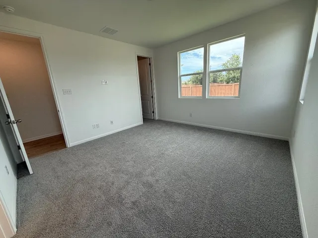 a kitchen with a sink a stove top oven and white cabinets