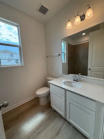 a bathroom with a double vanity sink mirror and shower