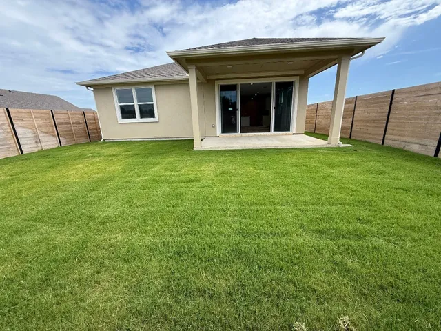 a view of a road with a big yard