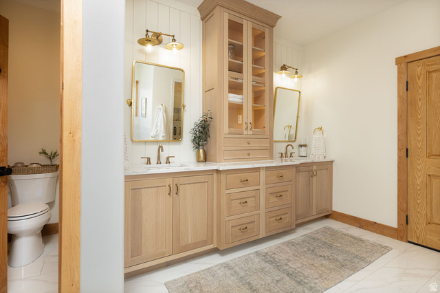 382 Ridgeview Street, Unit 8 & 9 Brian Head, UT 84719 - Photo 19 of 52 Dual vanity with light wood-finish cabinetry, white countertops, and brushed brass hardware