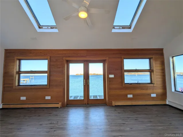 an empty room with window and wooden floor