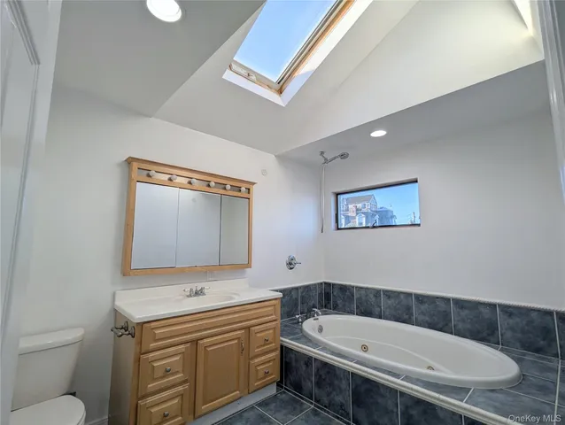 a bathroom with a sink a toilet and mirror