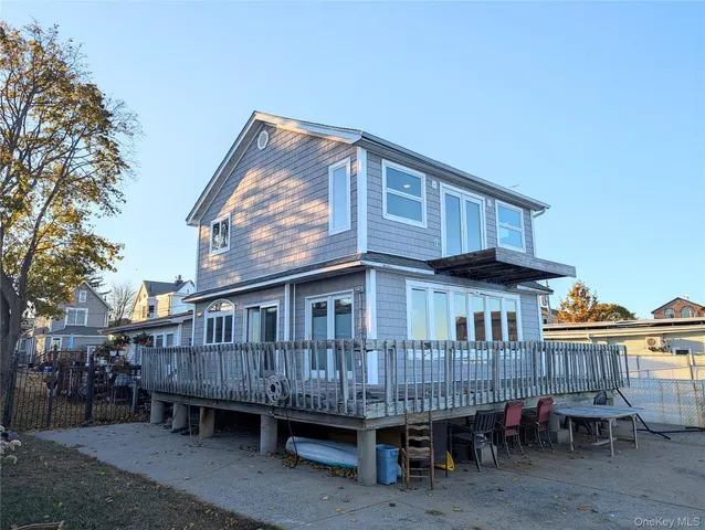 a backyard of a house with barbeque oven and outdoor seating