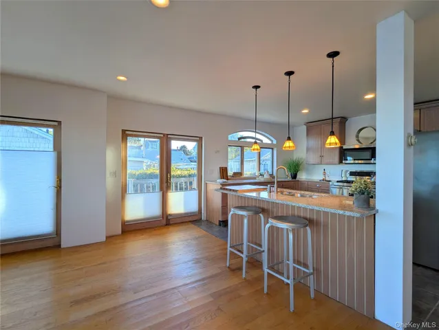a open kitchen with stainless steel appliances granite countertop a stove and kitchen island