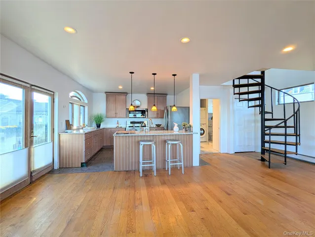 a living room with furniture and kitchen view
