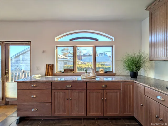 a kitchen with a sink and wooden floor