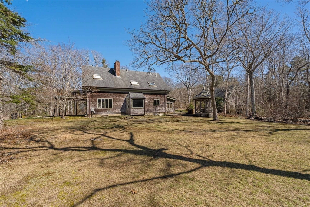 24 Beetle Swamp Road Edgartown, MA 02539 - Photo 3 of 33 a front view of a house with a yard