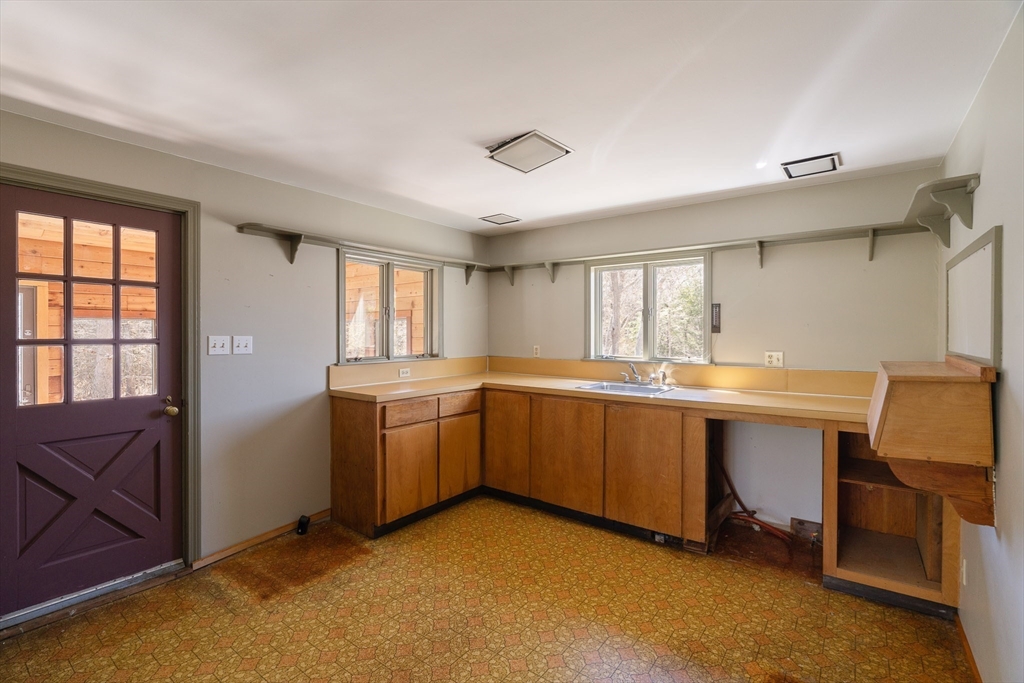 24 Beetle Swamp Road Edgartown, MA 02539 - Photo 5 of 33 a kitchen with sink cabinets and window