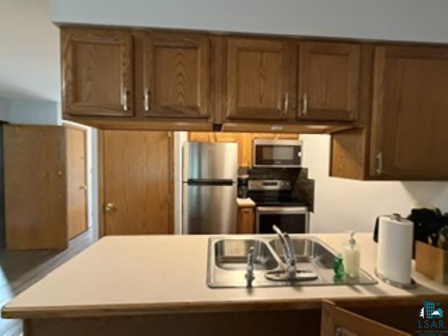 6266 Giants Ridge Road Biwabik, MN 55705 - Photo 10 of 30 Kitchen featuring wood-finish cabinetry, stainless steel appliances, and a double basin sink
