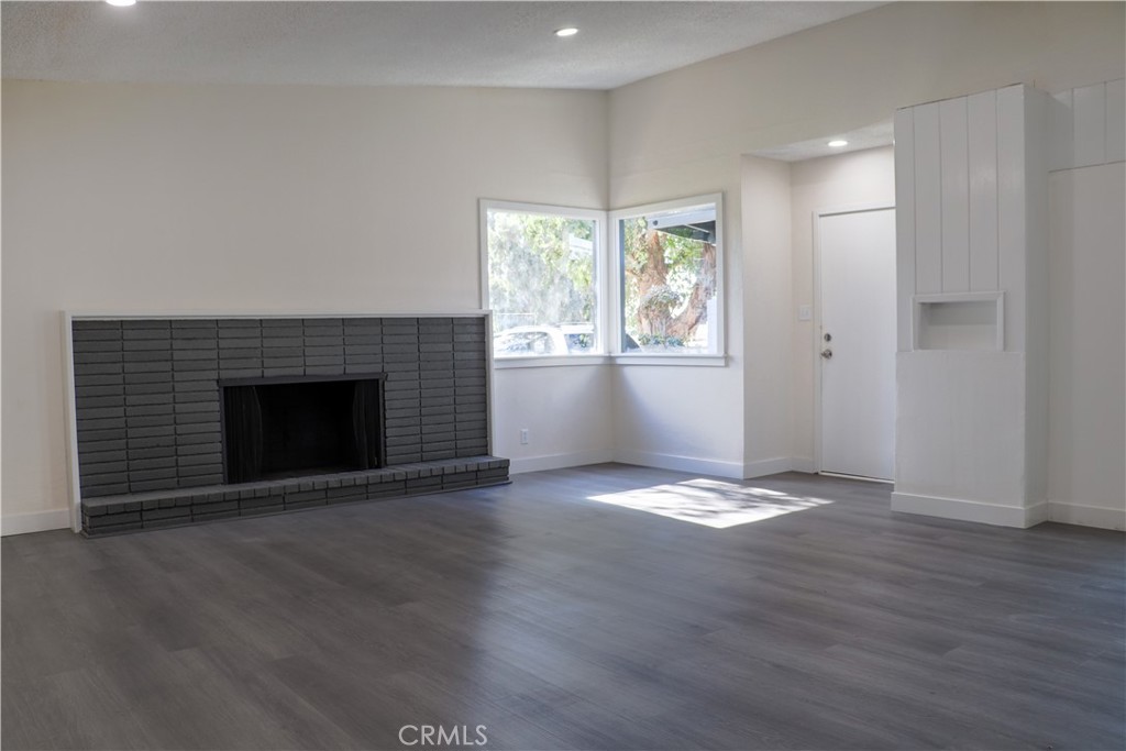 3323 Riverview Drive Jurupa Valley, CA 92509 - Photo 9 of 26 an empty room with wooden floor and fireplace